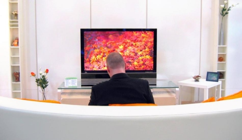 Fotografie muže sedícího před televizí