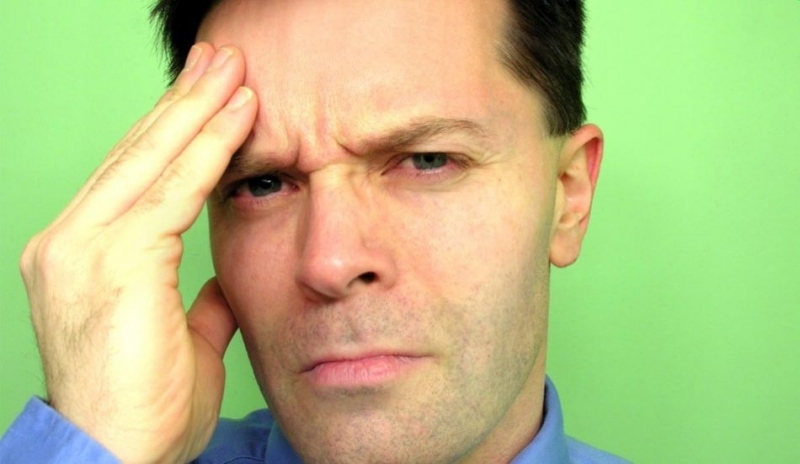 Fotografie muže  s rukou na čele