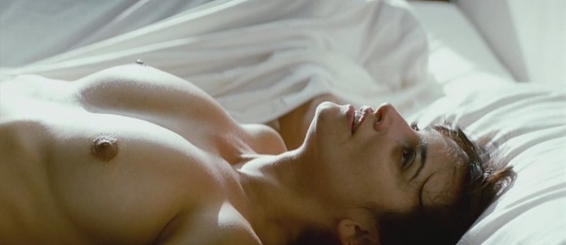 Fotografie nahé ženy v posteli